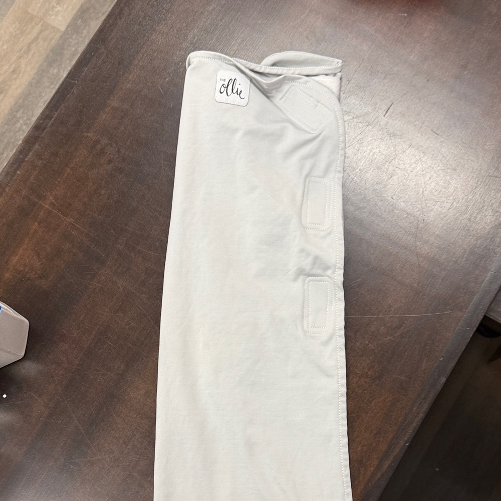 The Ollie Wrap Swaddle for Newborns in grey with mesh bag